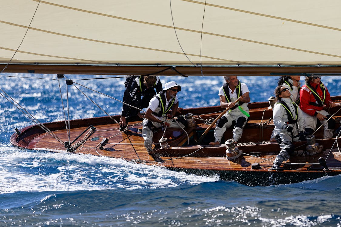 Crew working together on a sailboat during an instructional sailing charter